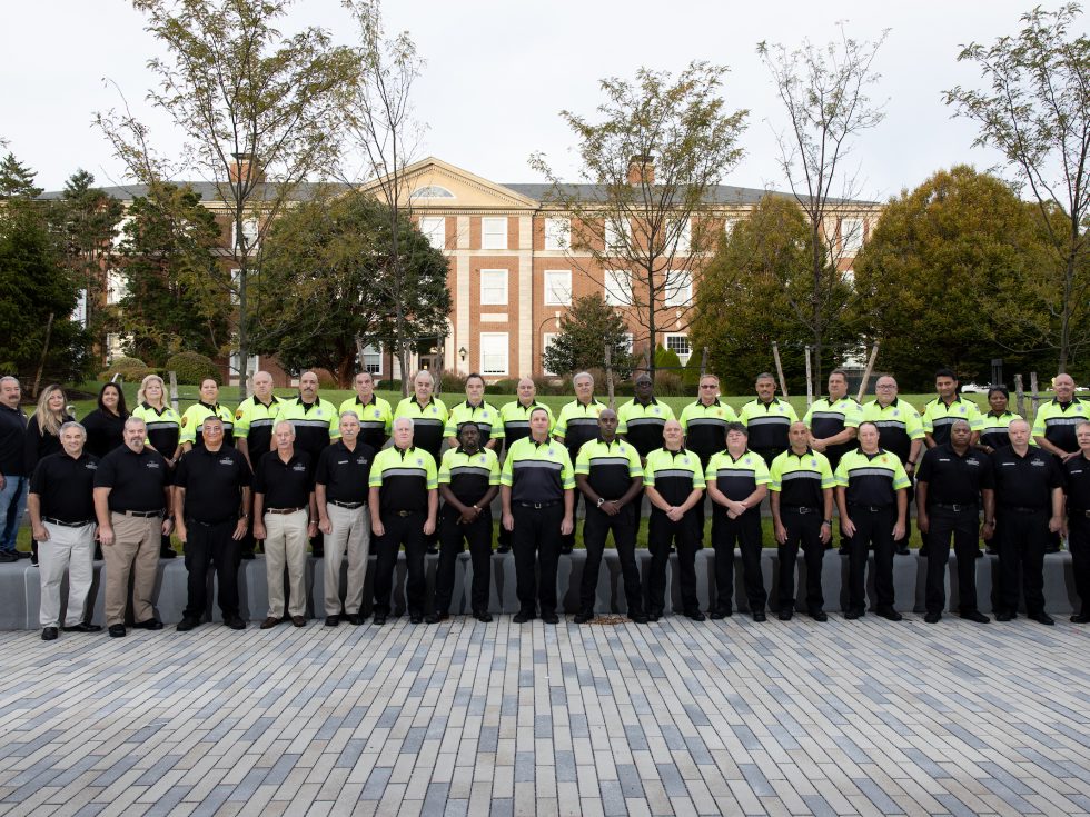 Adelphi University Public Safety department staff group photo on the Garden City campus. Officers in uniform.