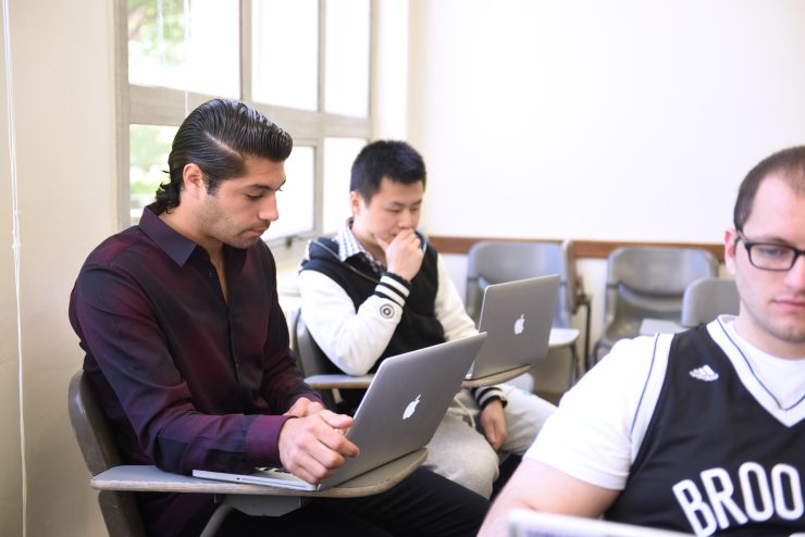 Students working on laptops in class