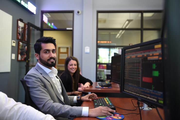 Adelphi students using Bloomberg terminals in the Riley Trading Room