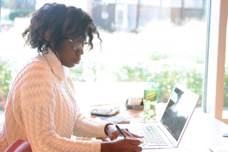 Student researching on a laptop