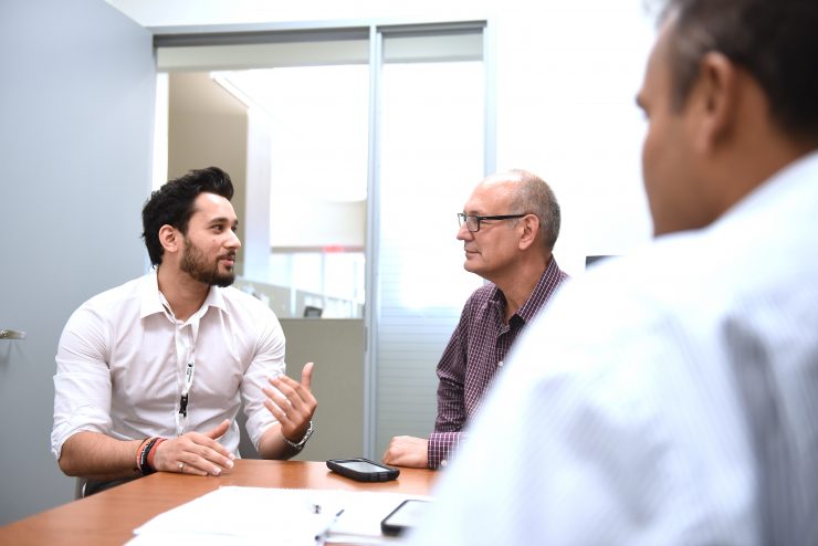 Professionals sharing ideas around a table