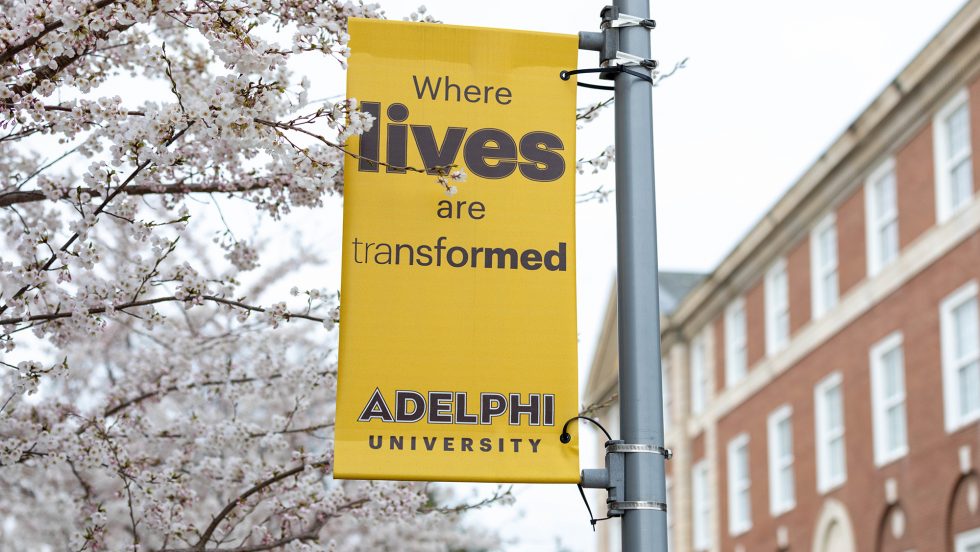 Adelphi University banner that reads "where lives are transformed"