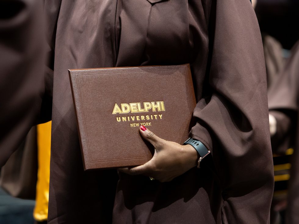 Holding an Adelphi University diploma