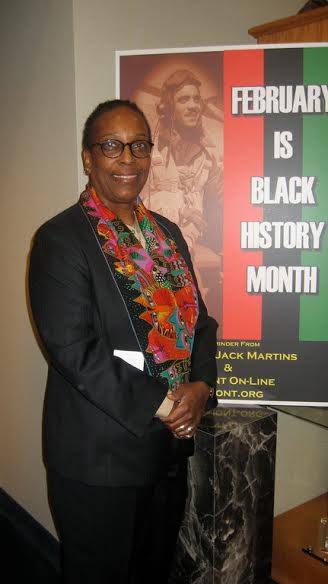 Marsha Darling standing near a black history month poster.