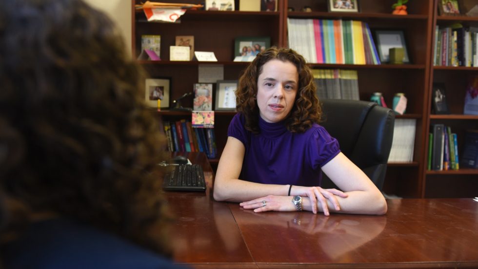 Professor Katherine Fiori, PhD sitting at her desk.