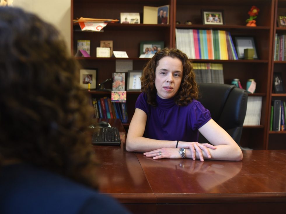 Professor Katherine Fiori, PhD sitting at her desk.