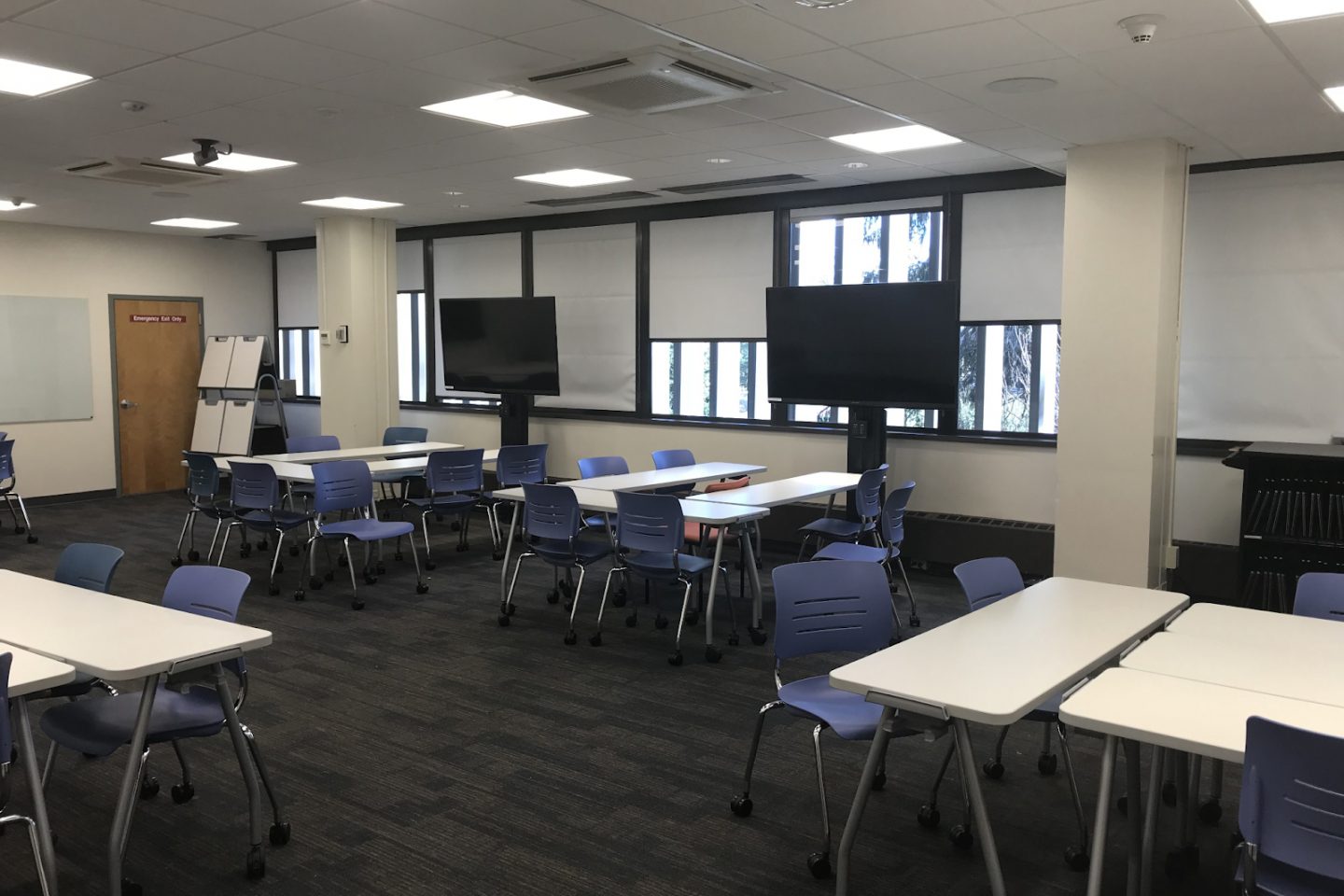 A view of the Gallagher Lab movable tables, group collaborative screens, and additional technology equipment.