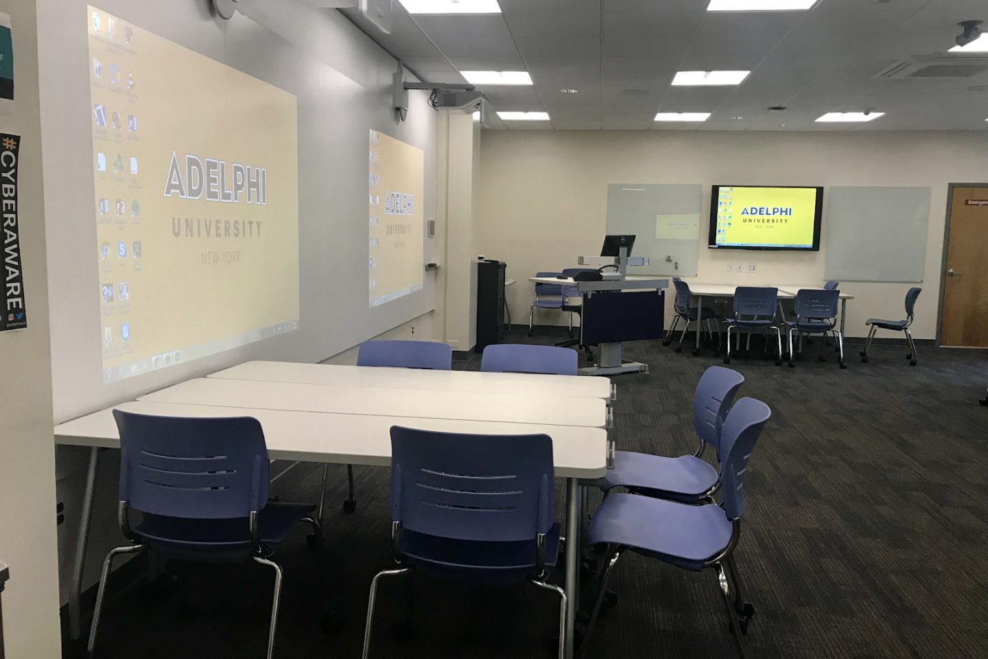 A view of the Hay Lab room technology, student seating and projector