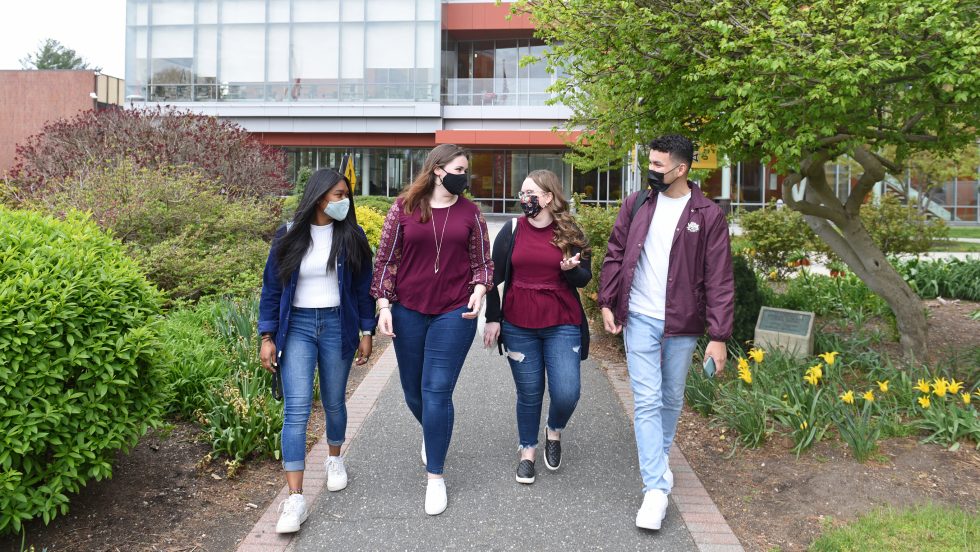 Adelphi students wearing masks on campus.