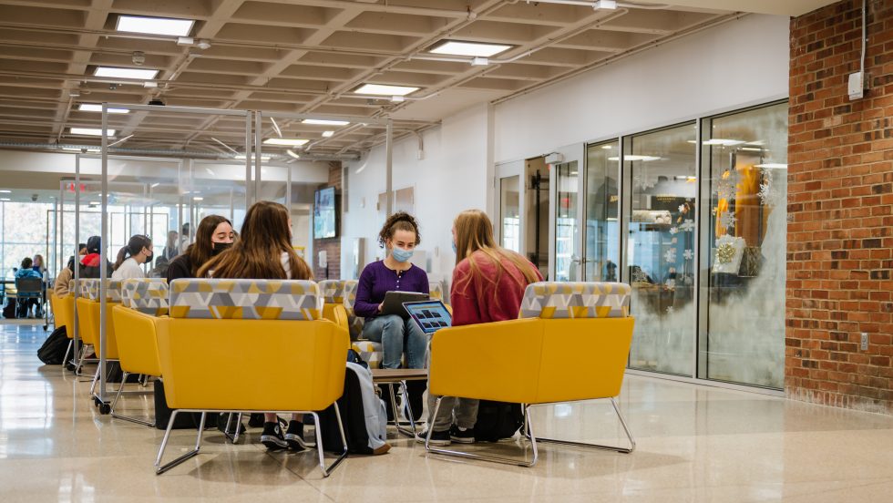 Adelphi students wearing masks while studying in the UC during COVID-19 pandemic.