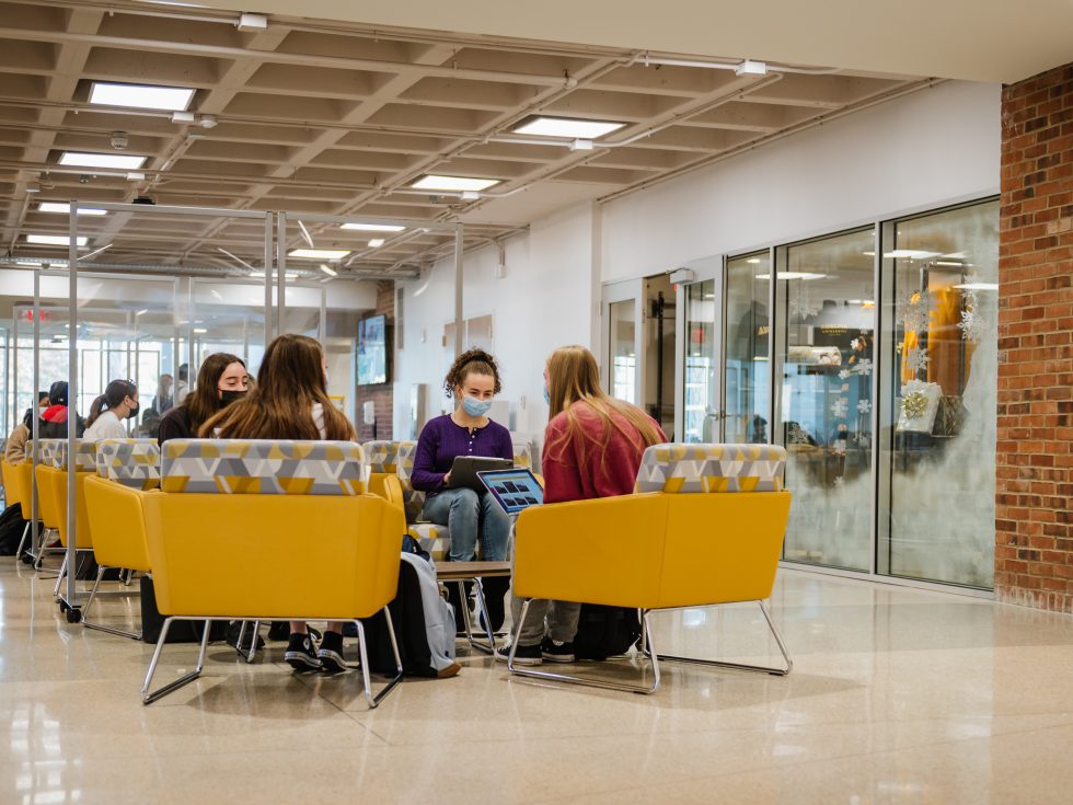 Adelphi students wearing masks while studying in the UC during COVID-19 pandemic.