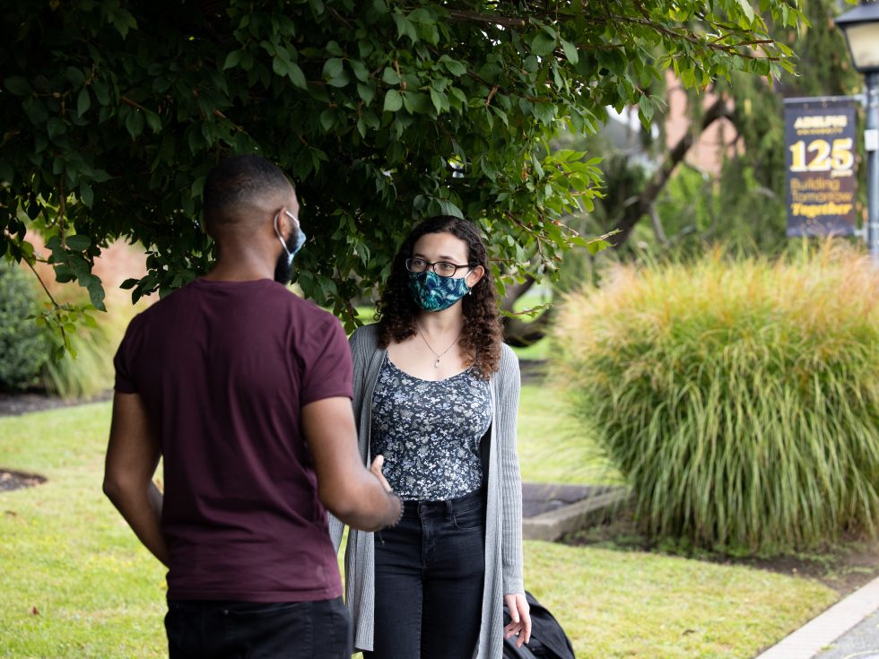 Adelphi students wearing masks and talking.