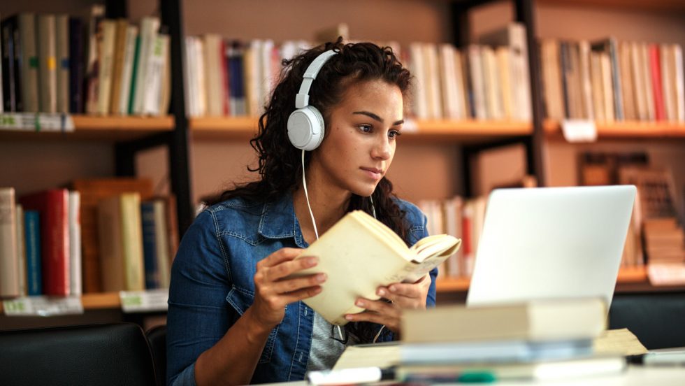 student learning remotely with headphones on.