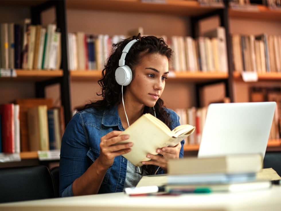 student learning remotely with headphones on.