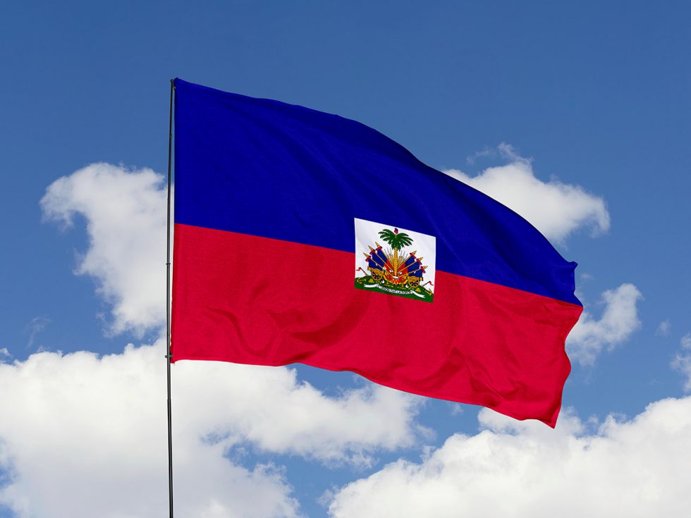 Haiti flag isolated on the blue sky with clipping path. close up waving flag of Haiti. flag symbols of Haiti.