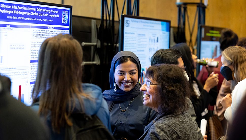 Research Day 2022 - a student research in front of her e-poster