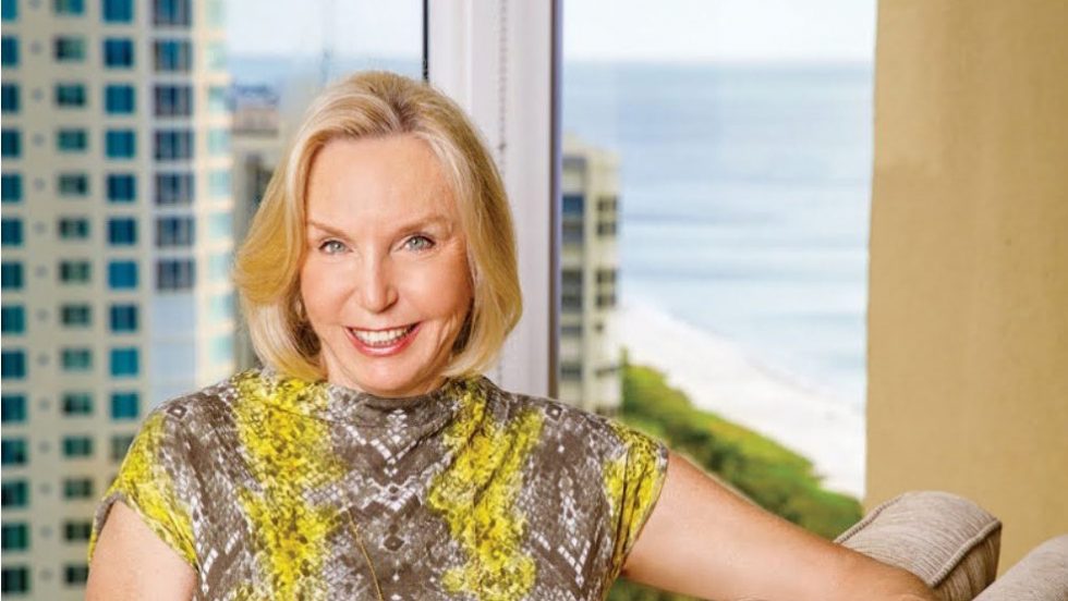 Paula Malone seated near a window.