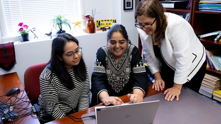 Professor of communication sciences and disorders Reem Khamis, PhD working closely with CSD students