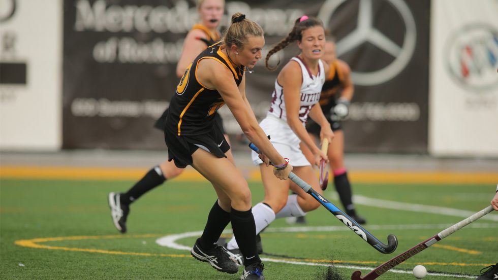Jacklyn Brown and players on the field hockey field.