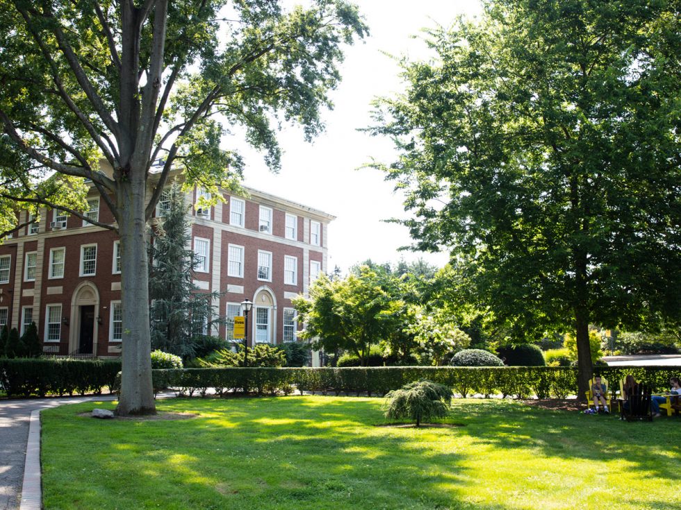 Blodgett Hall peaking through the lush trees on campus