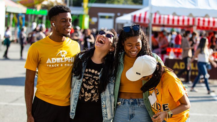 Adelphi students laughing together at the Panther Carnival during Adelphi University Spirit Weekend