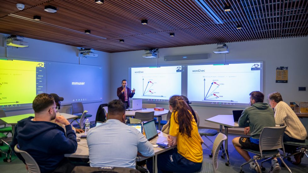 Juan Jaramillo, PhD, associate professor of decision sciences, leads a discussion in Adelphi’s Innovation Center. Students are encouraged to use Natural Language Process concepts learned in the classroom to create concrete innovative solutions to real problems.