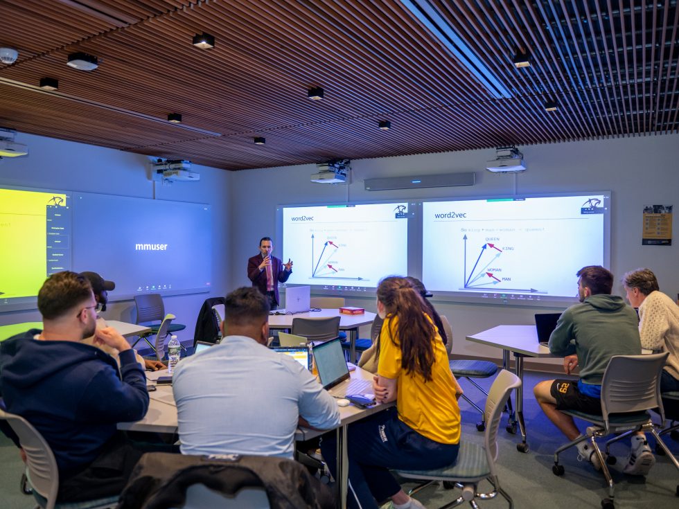 Juan Jaramillo, PhD, associate professor of decision sciences, leads a discussion in Adelphi’s Innovation Center. Students are encouraged to use Natural Language Process concepts learned in the classroom to create concrete innovative solutions to real problems.