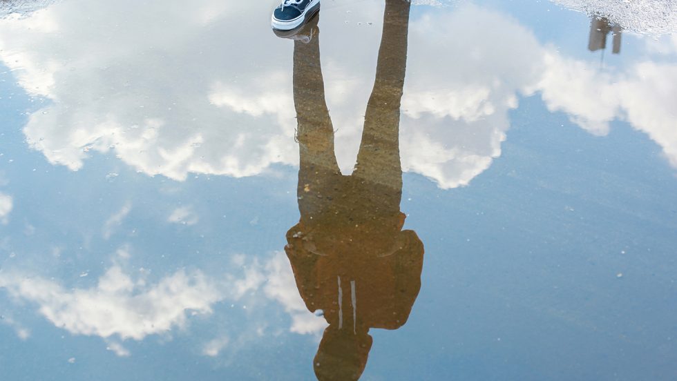 Photograph of a reflection through a puddle.