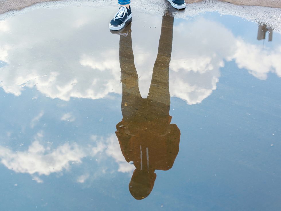 Photograph of a reflection through a puddle.