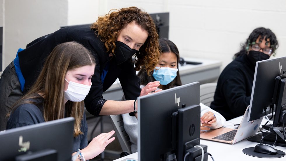 Katherine Fiori, PhD working with Adelphi University students while masked.