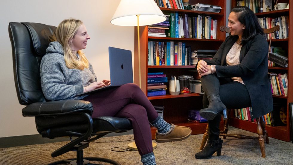 Monica Pal, PhD '13, speaking with a student at Adelphi's Center for Psychological Services and director of Practicum Training