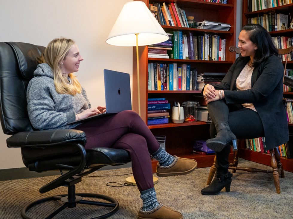 Monica Pal, PhD '13, speaking with a student at Adelphi's Center for Psychological Services and director of Practicum Training