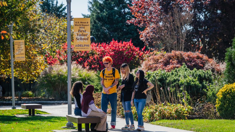 A group of Adelphi students enjoying the lush green campus in Garden City NY.