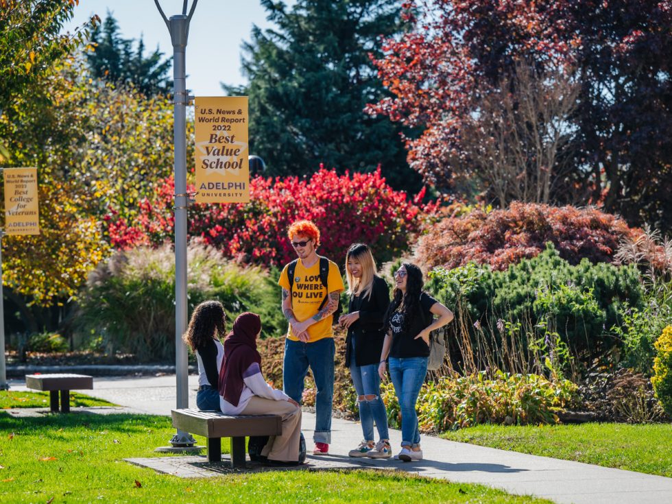 A group of Adelphi students enjoying the lush green campus in Garden City NY.