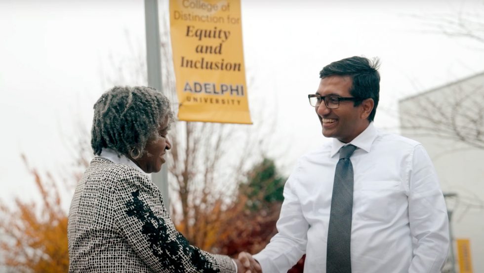 Fayth Vaughn-Shavuo, shaking hands with Pavan Antony, EdD