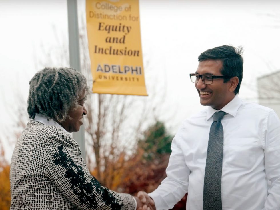 Fayth Vaughn-Shavuo, shaking hands with Pavan Antony, EdD