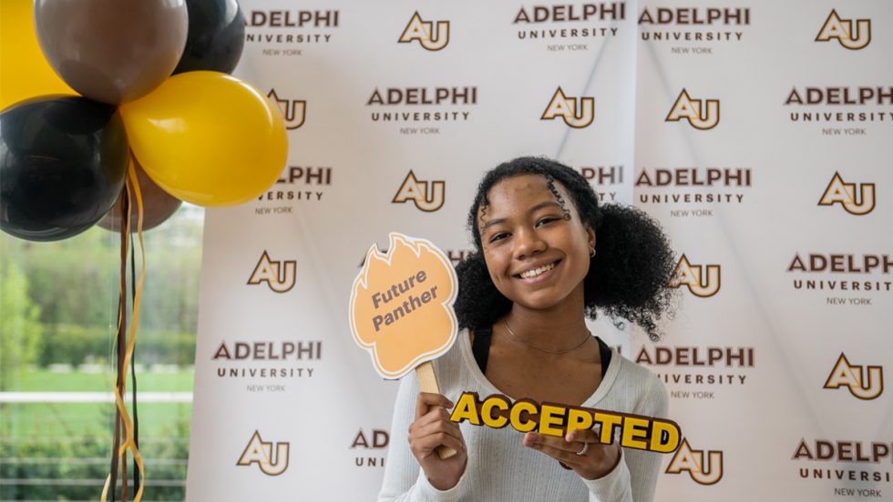 Accepted Student in Front of Adelphi Step and Repeat