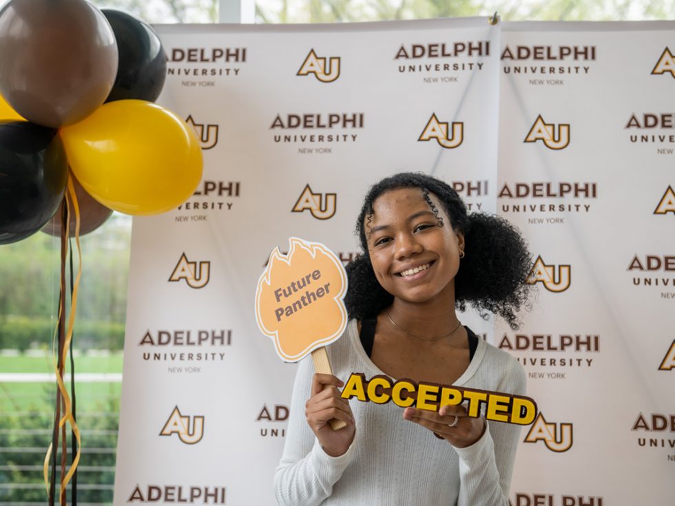 Accepted Student in Front of Adelphi Step and Repeat