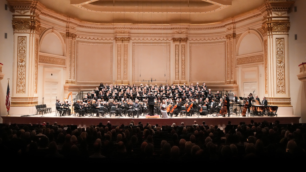 The orchestra, chorus and soloists of the Oratorio Society of New York, on stage at Carnegie Hall.