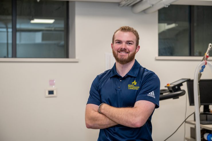 Adelphi student in the exercise science lab smiling.