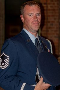 A man in military dress uniform, sergeant insignia on his sleeve