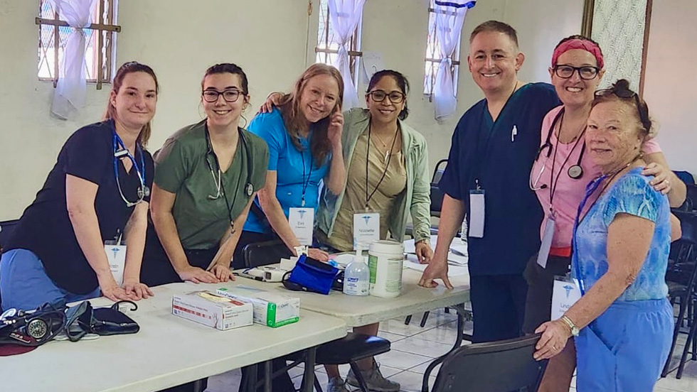 K.C. Rondello, MD, College of Nursing and Public Health clinical associate professor (third from the right), with six female staffers at a clinic for the underserved in Costa Rica in January