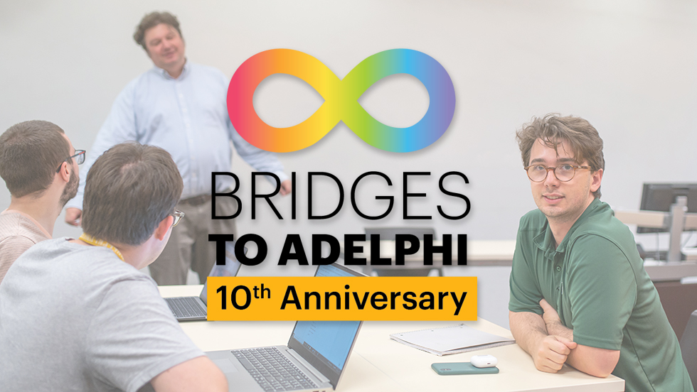 A Bridges student in an Adelphi physics class faces the camera. Two other students are seated across the table from him. A professor stands at the front of the class.