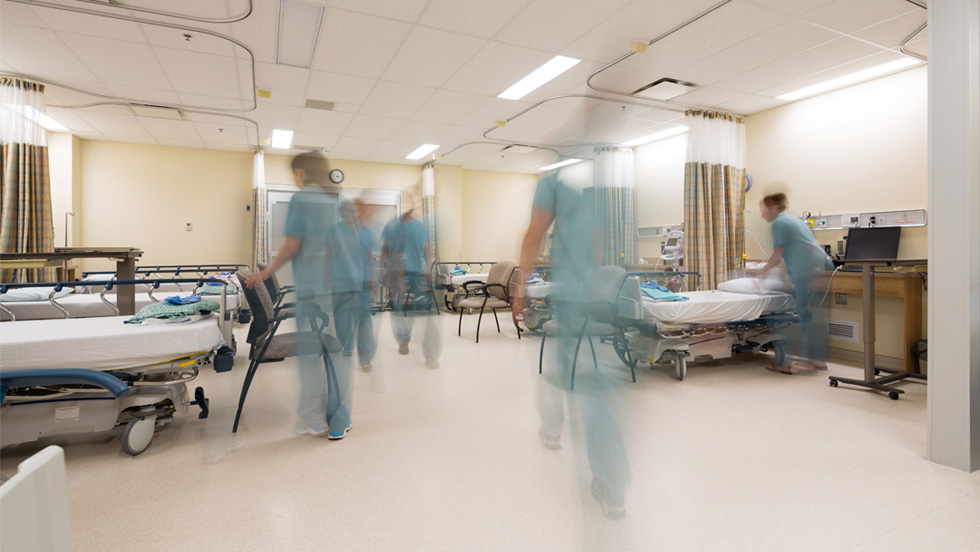 A time-lapse photo showing nursing students in motion in the Clinical Education and Simulation Lab hospital setting