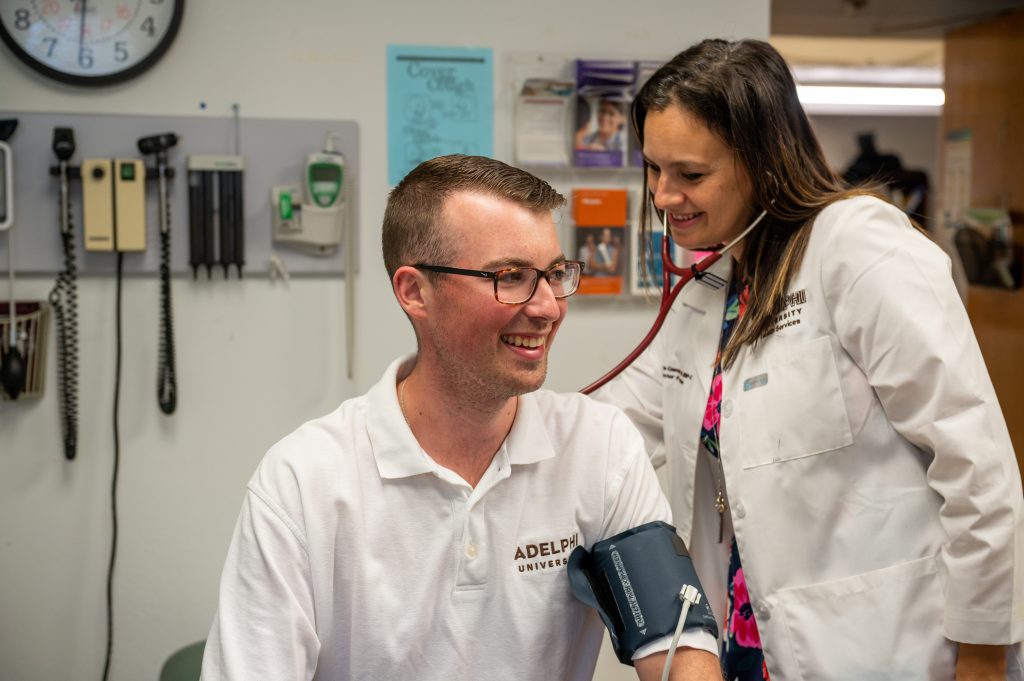 Nurse listening to heartbeat measurements at the Adelphi Health Services Center