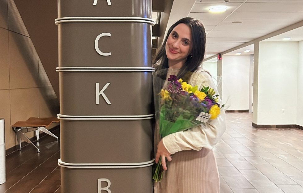 Katie Goz (pictured) outside of The Black Box Theatre at Adelphi's Performing Arts Center.
