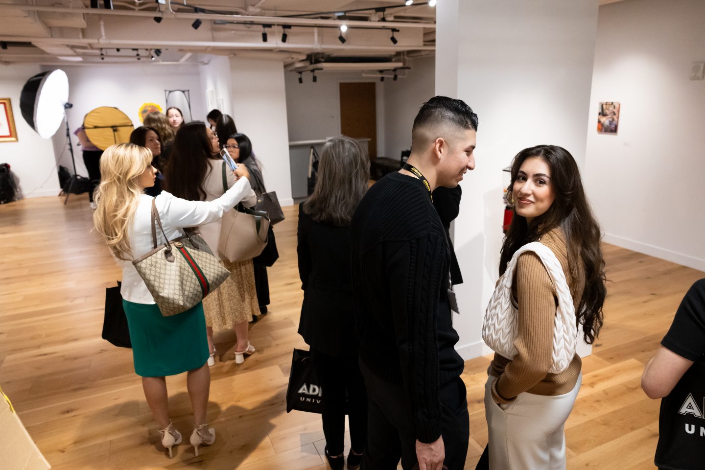 A long line of students and community members wait for professional headshots.