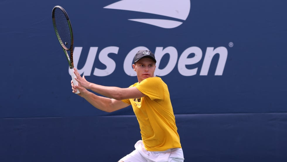 Tennis star Reece Farrow playing tennis for Adelphi University