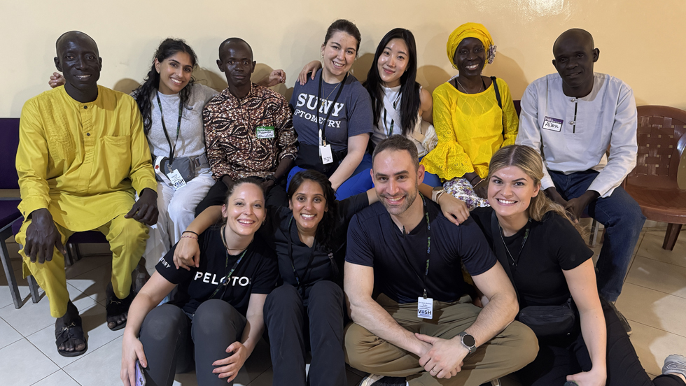 A group of smiling volunteers and medical workers in Senegal, West Africa.