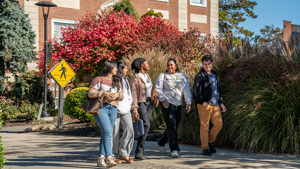 Adelphi University students walking on campus in he fall.